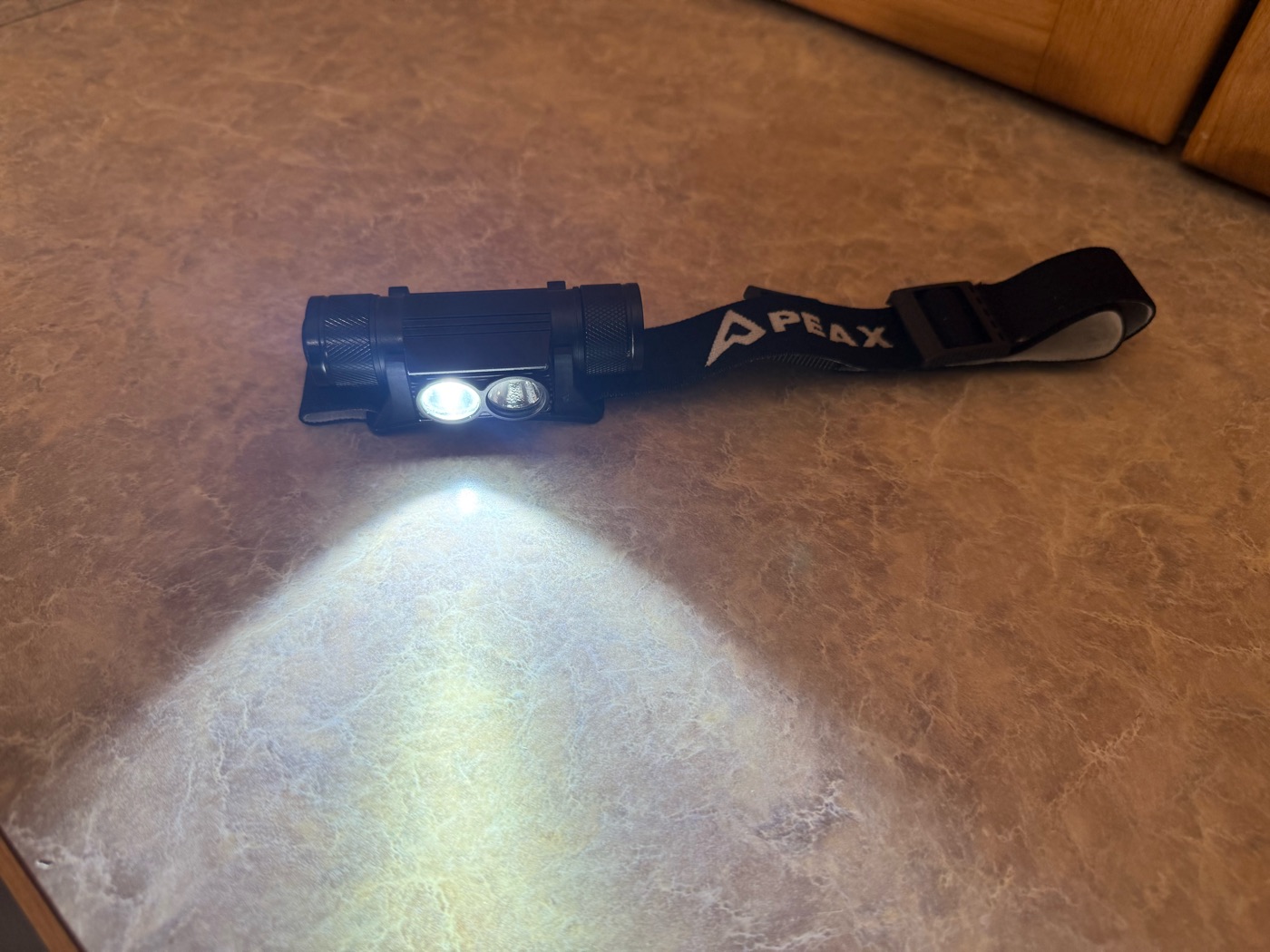 PEAX headlamp with the white mode on, casting a bright white beam