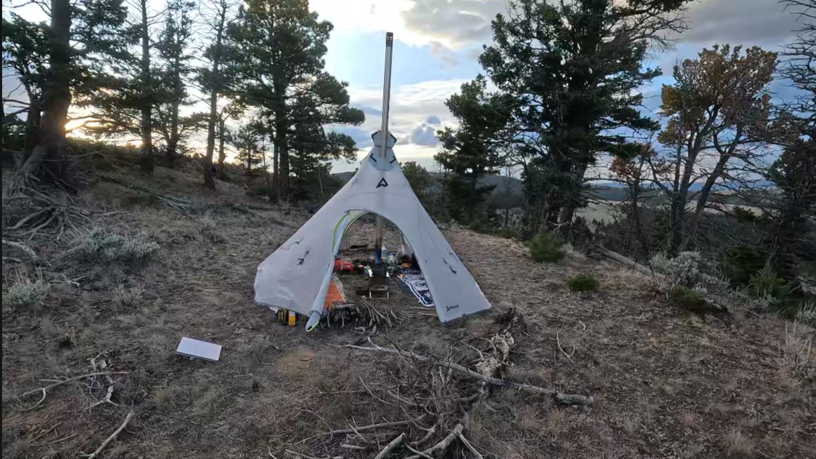 PEAX tipi at camp with the Winnerwell stove running and the 9-foot pipe through the stove jack